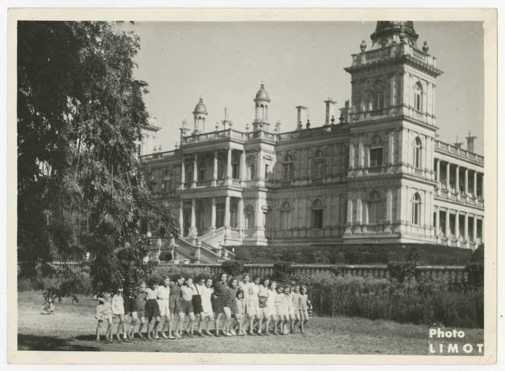 Children arm in arm in a line outdoors