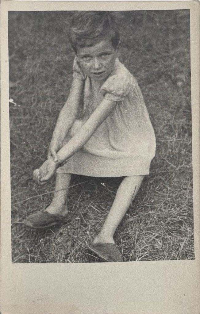 Photo of a chlid on the ground looking up to camera