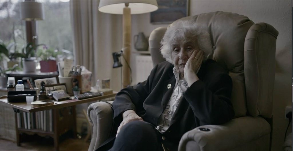 Anita Lasker sitting in a chair at home