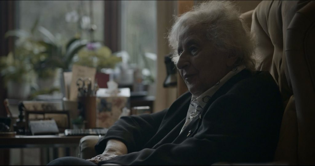 A profile shot of Anita Lasker sitting at home
